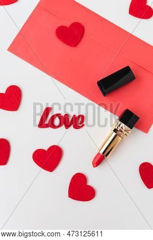 A Red Envelope With Red Lipstick On A Background Of Small Red Hearts.