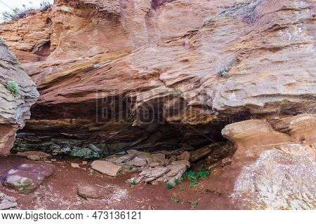 A Large Rock Formation On Rocky Coastline, Wonder Of Nature. Waves In The Process Of Erosion Eroded 
