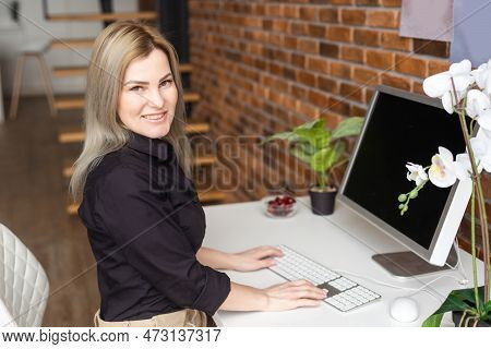 Successful Female Grapic Designer Watching Tutorial About Creative Ideas At Computer During Working 