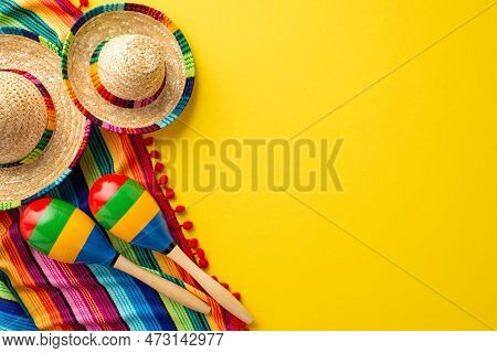 Cinco-de-mayo Concept. Top View Photo Of Sombrero Colorful Striped Serape And Maracas On Isolated Vi