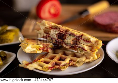 Pizza Waffles, Piffle. Waffles Stuffed With Sausage, Cheese, Tomatoes On A Plate.