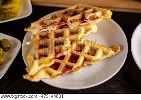 Pizza Waffles, Piffle. Waffles Stuffed With Sausage, Cheese, Tomatoes On A Plate.