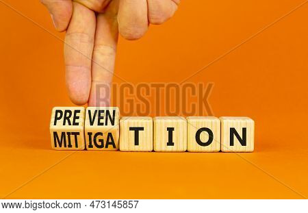 Prevention Or Mitigation Symbol. Businessman Turns Cubes And Changes The Concept Word Mitigation To 