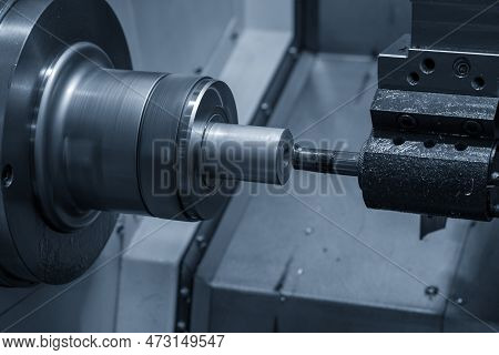 The  Cnc Lathe Machine Boring  Cutting The Metal Shaft Parts. The Hi-technology Metal Working Proces