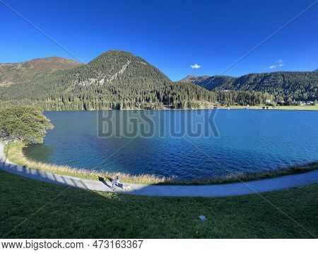 Sports And Recreational Trail Along The Alpine Lake Davos Or Loop Around Mountain Lake Davosersee, D