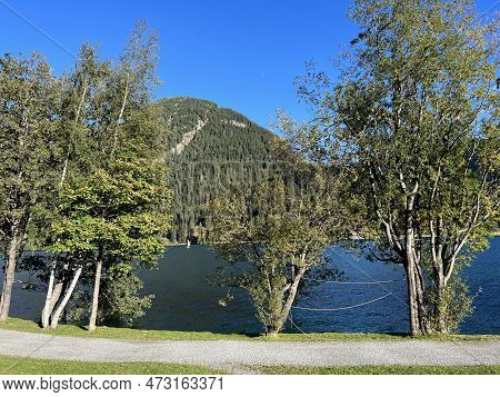 Sports And Recreational Trail Along The Alpine Lake Davos Or Loop Around Mountain Lake Davosersee, D