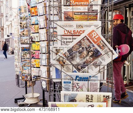 Paris, France - Mar 20, 2023: Pedestrians Walking Near Press Kiosk With Multiple French Press Newspa