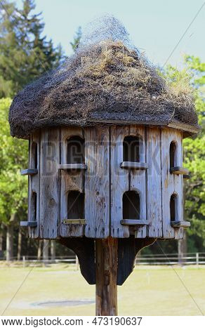 Closeup Of An Old Wooden Dovecote Standing In The Garden. Free-standing Empty Dovecot
