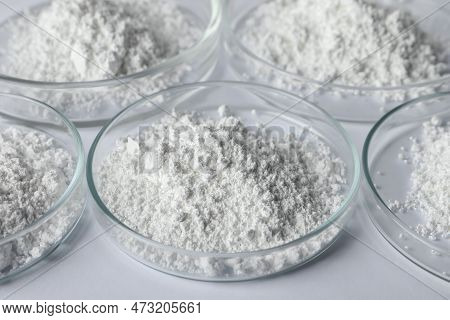 Petri Dishes With Calcium Carbonate Powder On White Table, Closeup