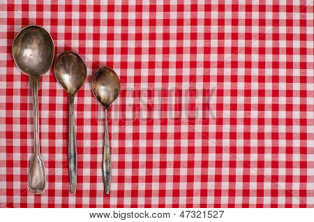 Silver Spoons On A Checkerd Cloth