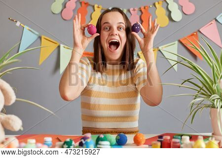 Image Of Cheerful Young Adult Woman With Brown Hair Wearing Casual Clothing Preparing For Easter, Ca