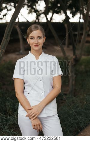 Smiling Confident Female Doctor With Lab Coat On Standing. Practician Woman
