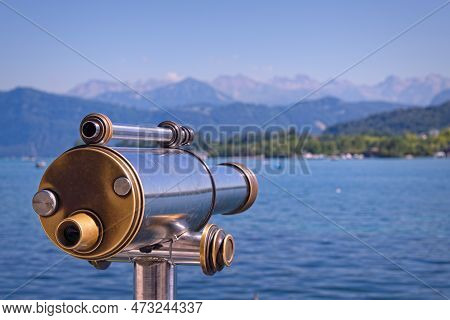 Old Antique Public Telescope For Viewing The Alps On The Shore Of A Lake In Lucern, Swtizerland