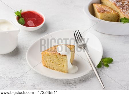 Freshly Prepared Mannik, Semolina Pie Sprinkled With Powdered Sugar With Sour Cream And Berry Sauce 