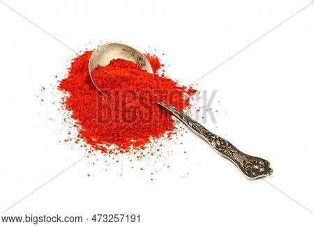 Close Up One Vintage Metal Spoon Full Of Red Chili Pepper, Paprika Or Sundried Tomato Powder Spilled