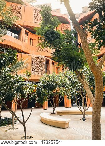 Uae, Abu Dhabi - 13th March, 2023: Eco-friendly Architecture And Trees In Masdar City, Abu Dhabi