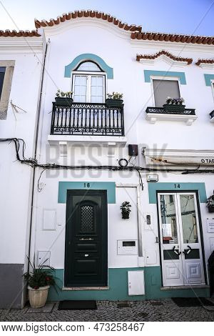 Alcochete, Lisbon, Portugal- October 21, 2022: Whitewashed Facade In Alcochete Town With Little Blue