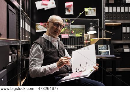 Senior Police Officer Analyzing Crime Scene Report, Reading Criminology Files. Private Detective Wor