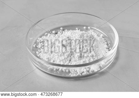 Petri Dish With Calcium Carbonate Powder On Grey Table, Closeup