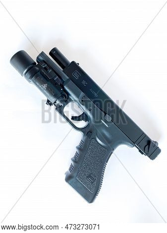 Bangkok Thailand - 21 March 2023: Air Soft Gun Glock 18C Pistol Gun With Flashlight Sight On The Whi