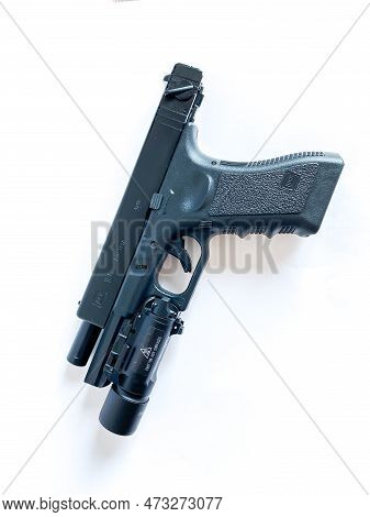 Bangkok Thailand - 21 March 2023: Air Soft Gun Glock 18C Pistol Gun With Flashlight Sight On The Whi