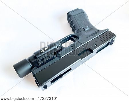 Bangkok Thailand - 21 March 2023: Air Soft Gun Glock 18C Pistol Gun With Flashlight Sight On The Whi