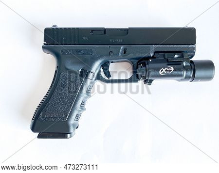 Bangkok Thailand - 21 March 2023: Air Soft Gun Glock 18C Pistol Gun With Flashlight Sight On The Whi