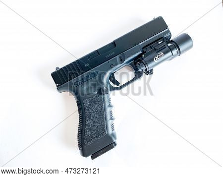 Bangkok Thailand - 21 March 2023: Air Soft Gun Glock 18C Pistol Gun With Flashlight Sight On The Whi