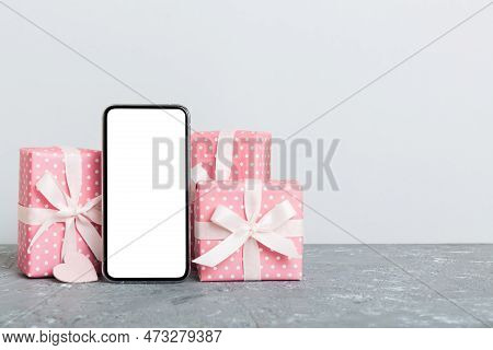 Mobile Phone With Blank Screen On Colored Background With Hearts, Calendar And Gift Box, Valentine D