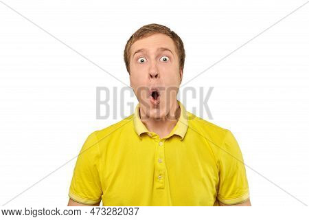 Surprised Young Man With Funny Facial Expression In Yellow T-shirt, White Isolated Background. Shock
