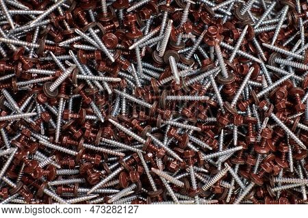 Bunch Of Galvanized Self-drilling Screws With Washer And Brown Hexagonal Head, Hardware Background. 