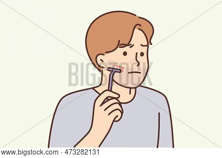 Man Using Manual Razor Cuts Himself During Morning Skincare Routine. Clumsy Young Guy Who Shaves Wit