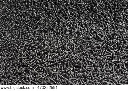 Bunch Of Black Oxide Stainless Steel Sheet Metal Screws With Pan Head, Hardware Background. Lot Of B
