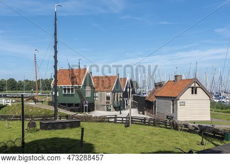 Enkhuizen, Netherlands - August 03, 2022: Ensemble With Historical Fishermen's Houses In The Zuiderz
