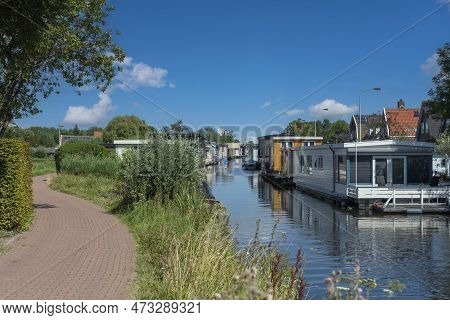 Houseboats On The Braakslot Canal In Zaandam District Kalf. Province Of North Holland In The Netherl