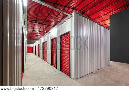 Corridor Of Self Storage Unit With Red Doors. Rental Storage Units
