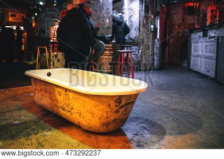Szimpla Kert, Famous Ruin Pub In Budapest Interior. Old Bathtub Placed In A Bar. Budapest, Hungary -