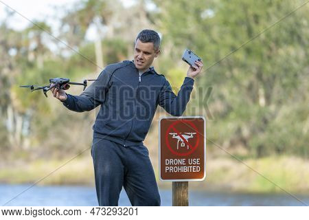 Man Is Sad That He Is Not Allowed To Fly His Quadcopter State Park No Drone Area. Operator Is Unauth