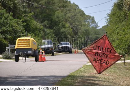 Road Work Ahead Sign On Street Site As Warning To Cars About Construction And Utility Works.