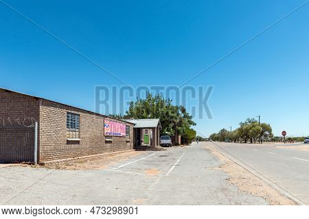 Groblershoop, South Africa - Feb 24, 2023: A Street Scene, With A Business And Vehicles, In Groblers