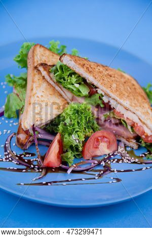 Breakfast Sandwich Toast With Salad. Blue Background. Bread, Beakon Tomatoe On Plate Top View. Meat 