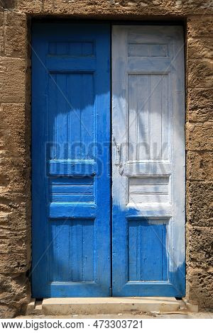 A White And Blue Closed Door In The Lebanese Town Of Batroun.