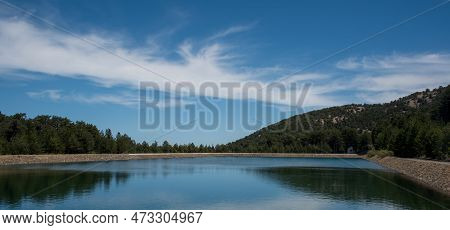 Panoramic View Of Dam Full Of Water In The Forest . Prodromos Water Reservoir Troodos Mountains Cypr