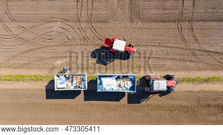 Above Top View On Two Farmers As Reloading Artificial Fertilizer From Trailer, Full Of Stuffed Sacks
