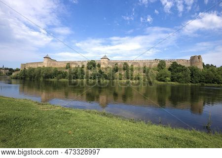 View Of The Russian Ancient Ivangorod Fortress From The Estonian Bank Of The Narova River On A Sunny
