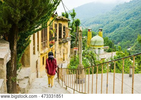 Tourist Woman Walk In Scenic Masuleh Village In North East Iran - Popular Famous Tourism Destination