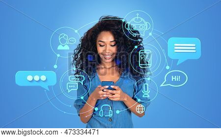 Smiling African Woman Working With Chatbot Online In Mobile Phone. Chat Bot Hologram Icons, Using Ai