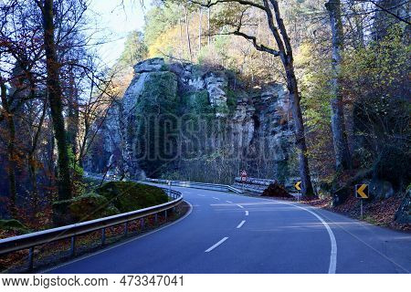 Road Through High Limestone Rock Wall In Berdorf, Mullerthal Region, Luxembourg. Blue Shadows In Dee