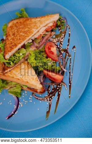 Breakfast Sandwich Toast With Salad. Blue Background. Bread, Beakon Tomatoe On Plate Top View. Meat 