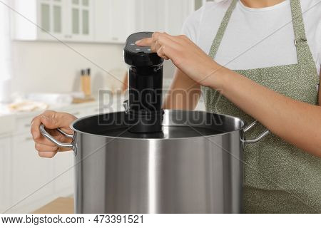 Woman Using Thermal Immersion Circulator In Kitchen, Closeup. Sous Vide Cooking